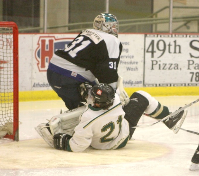 Athabasca Ace Jody Tangedal crashes into Daniel Harvard of the Edson Ice during the first period of Saturday night&#8217;s 8-3 loss at the Athabasca Regional Multiplex.