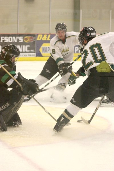 Athabasca Aces Sean Kiselyk (r) and Andy Skoreyko (l) crash the Rocky Mountain House Rams&#8217; goaltender and net during the second period in Sunday&#8217;s 8-2 win over