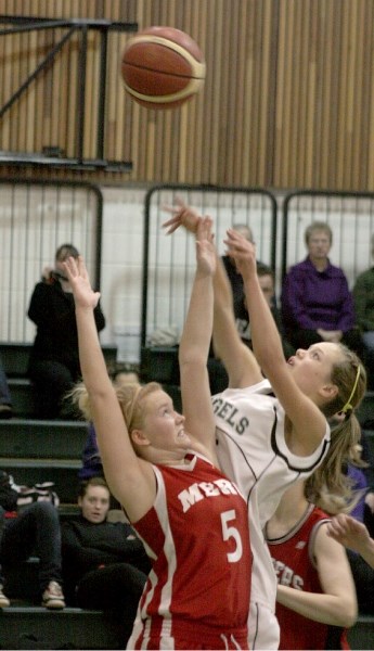 EPC Senior Angel Jackie Elgert takes a shot over a Fort McMurray Trapper during the fourth quarter of the bronze medal match in a tournament hosted by Athabasca. The Angels