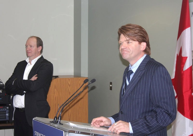 M.P. Brian Jean announces government investment of $62.9 million into Al-Pac at the mill last Thursday while plant CEO Alan Ward looks on.