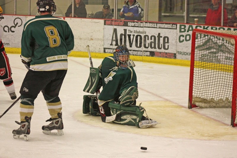 Athabasca Aces goaltender Jeff Creaser kicks out a Legal Vipers shot during game action on Sunday, Jan. 9. The Aces won 7-6.