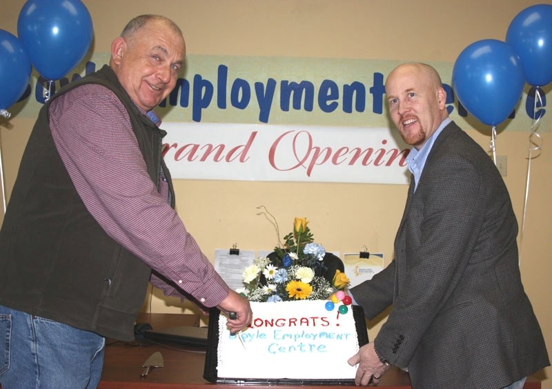 Athabasca-Redwater MLA Jeff Johnson (r) cuts the cake with Boyle Mayor Don Radmanovich at the Boyle Employment Centre&#8217;s grand opening last Tuesday.