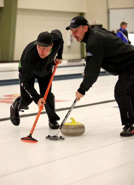 Second Dustin Nyal (left) and third Darcy Tarrant of the K-Ridge team compete in the 2011 Oilmens Bonspiel at the Athabasca Regional Multiplex last weekend.