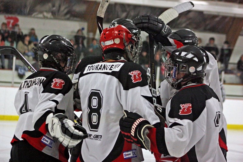 Khalid Tourangeau (8) of the Bantam Boyle Blazers is mobbed by his teammates after scoring a goal against Smoky Lake early in the second period on Friday night. The two teams 