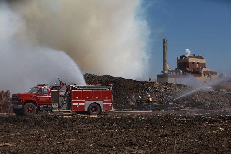 Fire crews from Grassland, Boyle, Sustainable Resource Development and Al-Pac&#8217;s own, work diligently to extinguish a hog pile that caught fire Sunday afternoon.