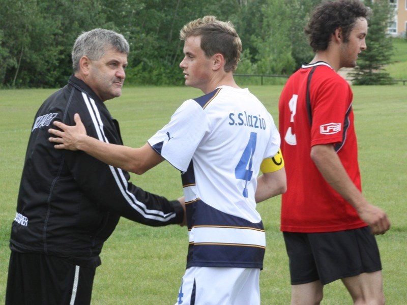 Jon LeMessurier and his father (and opposing coach) Brian shake hands after the game between S.S. Lazio and the Athabasca All-Stars.