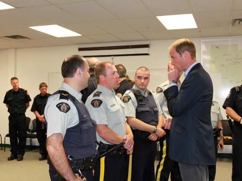 (From left) Officers Cuneyt Zanbak, Doug Fossen and Matt Lapointe speak with Prince William about evacuation efforts. Not pictured is Sheriff Mark Handley.