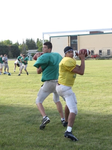 Athabasca Pacers quarterbacks Michael Pieroway (left) and Gaetano Minto work on getting into game shape during training camp last week.