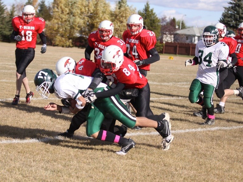 Gaetano Minto (17) of the Athabasca Pacers is hauled down by Westlock players as his teammate Jeremy Major (34) looks on during the team&#8217;s 21-7 loss last Saturday.
