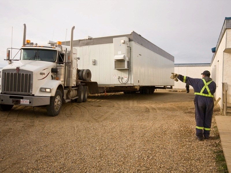 Workers from Triple H Transport brought the modular classroom from Athabasca University, carefully placing it at the back of Whispering Hills Primary School.