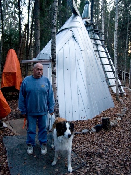Radomske and Blaze stand in front of the tee pee shelter they sleep in.