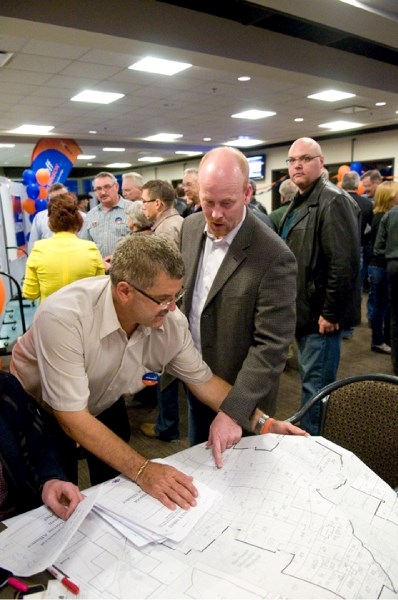Brian LeMessurier and Jeff Johnson look at a constituency map in regards to the voting.