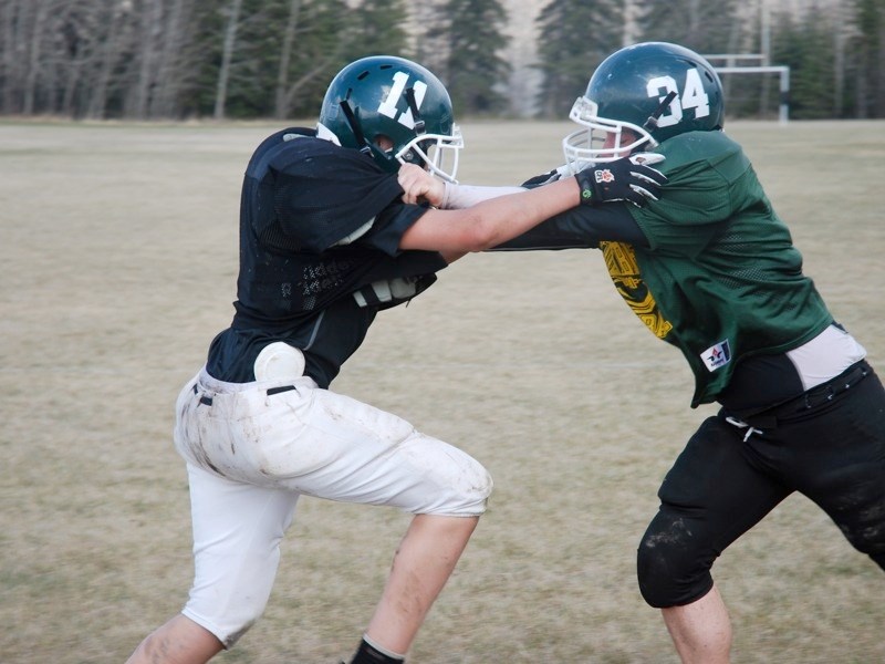 The Pacers football club from Edwin Parr Composite is on the field for their spring camp. (clockwise from top left) Joe Karayel (left) and Jeremy Major battle.