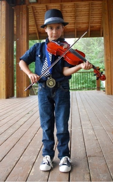 Young Hardy Loomis is already an accomplished fiddler at the age of six.