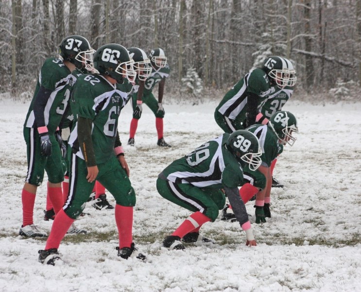 The Athabasca Pacers meet at the line of scrimmage during their snowy game against Vegreville last Friday.