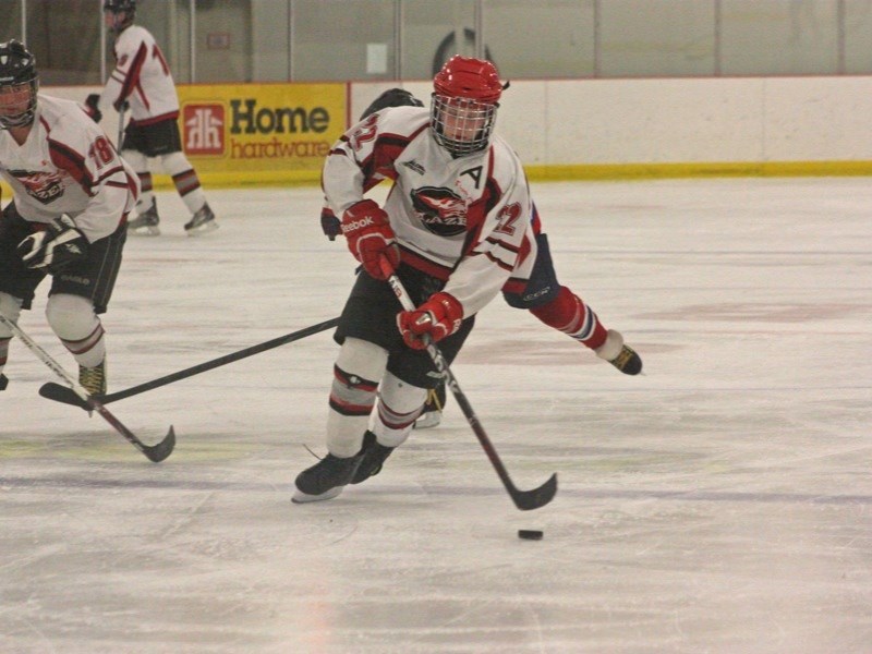 Wes Thompson of the Midget Blazers breaks up the ice on his way to scoring against St. Paul last Friday.