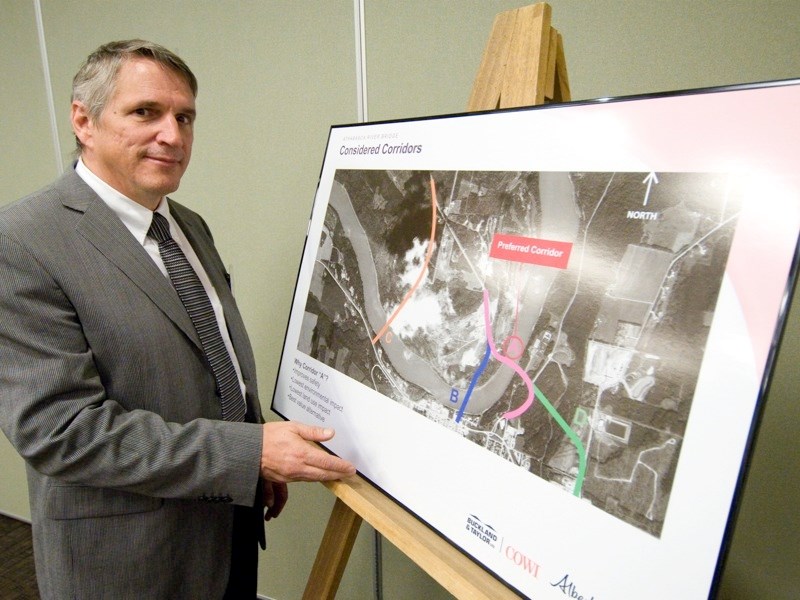 Dale Scrink points at the three options being looked at for the relocation of the Athabasca River bridge on Hwy 813.
