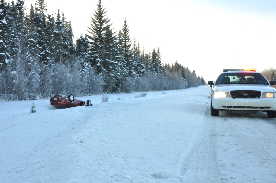 A burgundy Dodge Intrepid lies in the ditch along Hwy 55 just east of Athabasca after the driver lost control.
