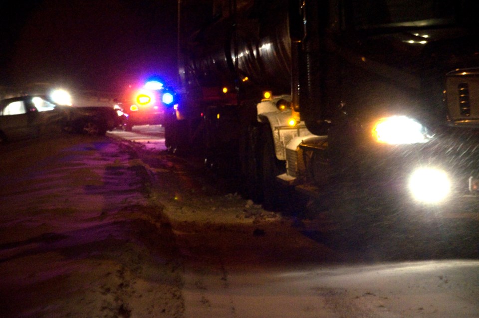 A light coloured sedan, pictured left, part way in the ditch at the bottom of the east hill in Athabasca, was struck by the oncoming pickup truck as the sedan attempted to
