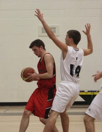 Davis Weber of the Edwin Parr Composite senior boys basketball team defends against a member of the R.F. Staples Thunderbirds during game action at EPC last weekend.