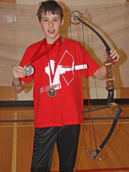 Brendan Osachie shows off his new bow, a symbol of his status as Alberta&#8217;s top elementary school archer.