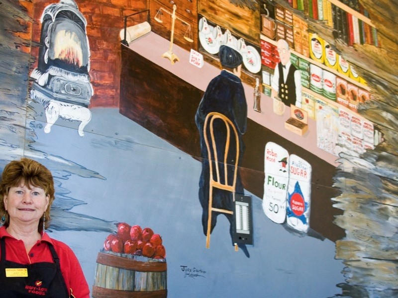 Judy Gauthier takes pride in her mural at the entrance to Buy-Low Foods.