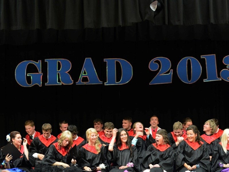 The Boyle School class of 2012 –2013 is jovial after throwing their mortarboards into the air.