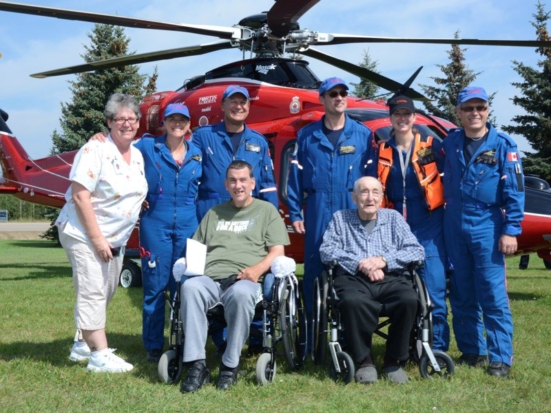 (l-r) (back row) Brenda White (health care aide) Lori Coutts (STARS flight nurse), Greg Cars (STARS pilot), Andre Rioux (STARS pilot), Sherry Brooks (STARS flight nurse) and