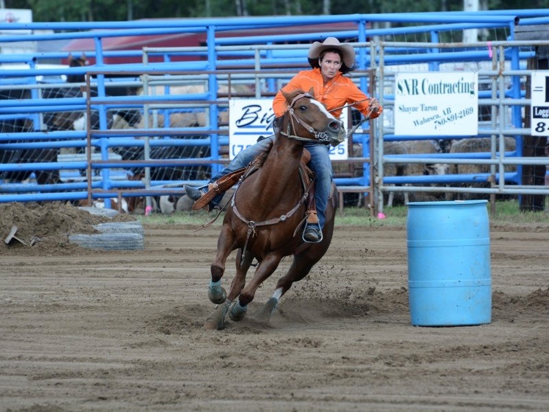 Ladies barrel racing winner Lana Chorney rounds a barrel at the Smith Rodeo last Saturday.