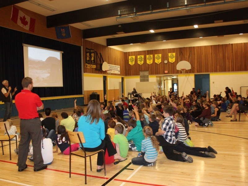 There were plenty of questions for Dr. Philip Currie (far left) when he presented on dinosaurs — and touched on their connection to birds — at Landing Trail Intermediate