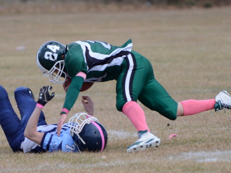 EPC Pacer Mitchell Snow is pulled to the ground by a Vegreville Vortex player who grabbed onto his mask during last Saturday&#8217;s playoff game in Athabasca. The Vortex