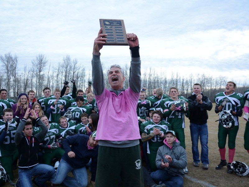 Edwin Parr Composite Pacers head coach Pete Burden holds up a plaque commemorating the Pacers&#8217; Wheatland Football League tier two championship win over Westlock last