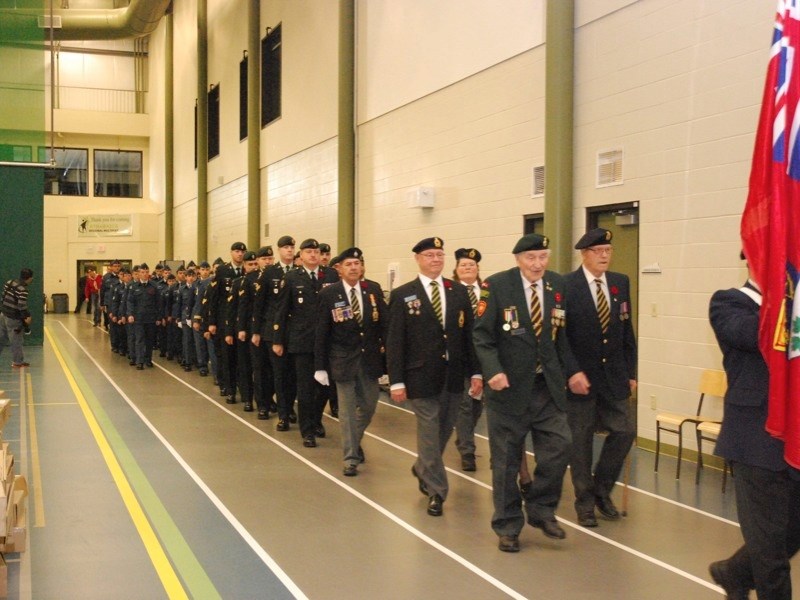Veterans and other members of the procession march into the Athabasca Regional Multiplex&#8217;s Jim Woodward Fieldhouse during last year&#8217;s Remembrance Day event.