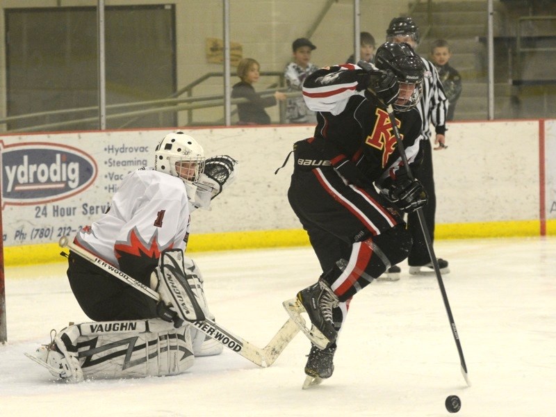 AA North Central Bulls midget goaltender Mason Gautier keeps a close eye on a Knights of Columbus Colts player from Edmonton last Friday. The Bulls are ranked fifth amongst