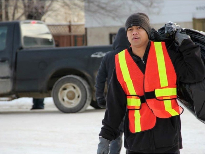 Romel Llamson collects bottles during a bottle drive organized by Athabasca&#8217;s Filipino community late last month. The drive raised more than $2,000 on Nov. 30 alone.