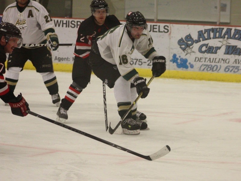 Brent Hill (21) and Shaun Kiselyk (16) bear down on the puck.