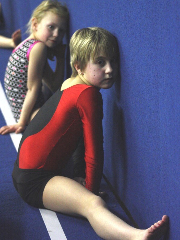(l-r) Quinn Dubie and Bethanie Wagner practise the splits at an Athabasca Flips Gymnastics class. The girls are training for their first-ever competition next month.