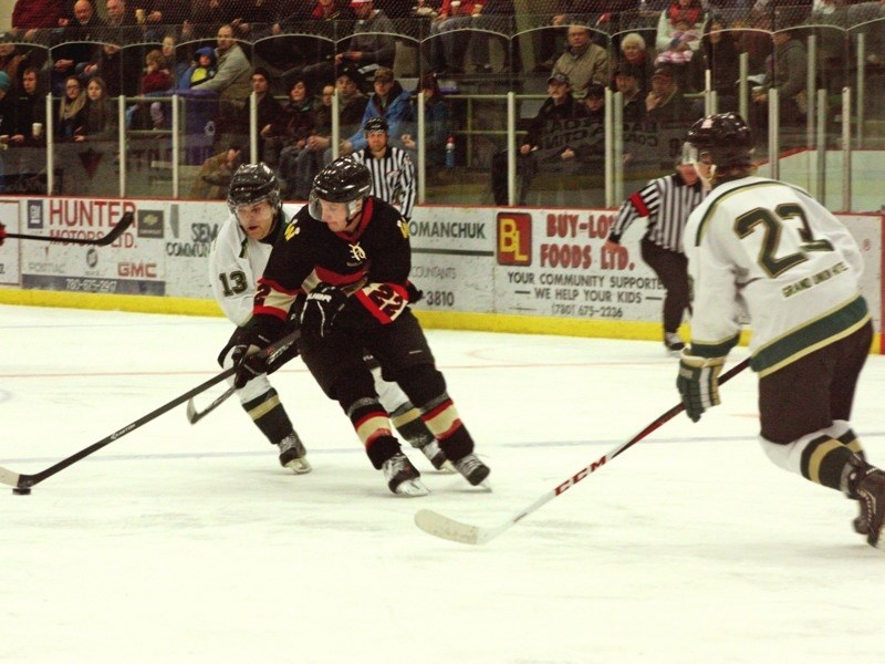 Athabasca Aces player Alfred Lavalee shadows Westlock Warriors player Dave Carr at the Athabasca Regional Multiplex last Friday. The Aces lost to the Warriors 5-4.