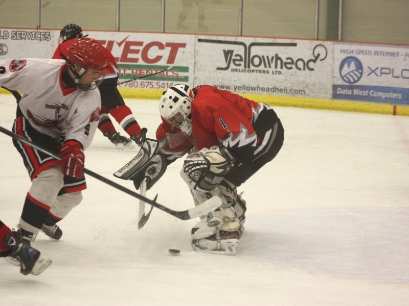 Midget AA Bulls goalie Mason Gautier faces a Vegreville Wranglers player at the multiplex Sunday.