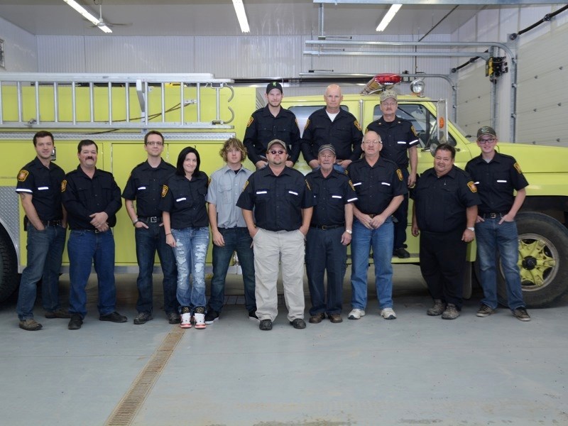 The Colinton Fire Department has been using a retrofitted ambulance as its rescue truck and says it is time for a new vehicle. (front row, l-r) Geoff Loken, Mike Seguin, Adam 