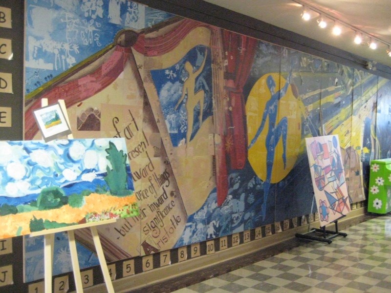 A Calgary Arts Academy hallway where one of several pianos available for students to play at their leisure is visible on the far right.
