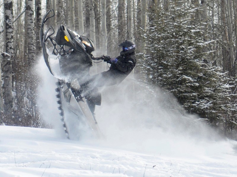 Eric Bendrien from Athabasca shows off for his friends by performing a cat walk during the Athabasca River Runners annual poker rally, which doubled as the Alberta Snowmobile 