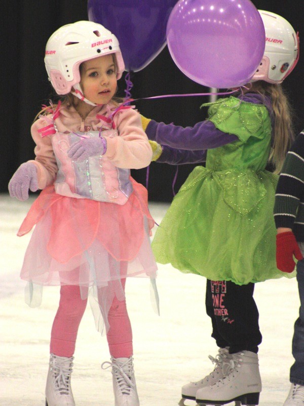 Tots Taylor Brown and Paityn Franzen (behind the balloon) enjoy their balloons at the end of the Athabasca Figure Skating Club&#8217;s annual carnival last Sunday at the