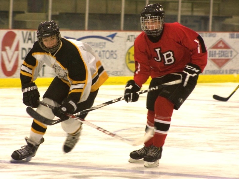 Athabasca midget Winter Hawks player Iver Steffes chases the puck against a Jasper defender during game two of the Bearcats/Winter Hawks playoff series. Jasper won the game