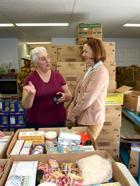 (r-l) Premier Alison Redford speaks with Good Samaritan Mission coordinator Lois Uchytil during a tour of the mission on March 14. Redford visited the mission after giving a