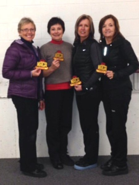 Bev Topola, skip, Audrey Shapka, third, Shannon Demko, second, and Sherry Tebbenham, lead, with their Northern Alberta Curling Association Cup trophies.