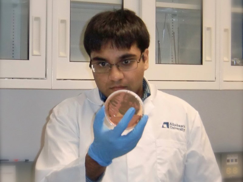 Bachelor of science student Neel Doshi holds a dish containing bacterial cultures. In the latest Science Outreach program on May 9, Doshi will give a lunch-hour talk about