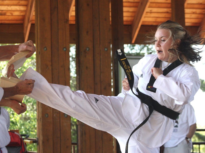 Shaylin Strome kicks through a piece of wood while testing for her second-degree black belt in taekwondo. Athabasca Champion Taekwondo did its promotion testing last Saturday 
