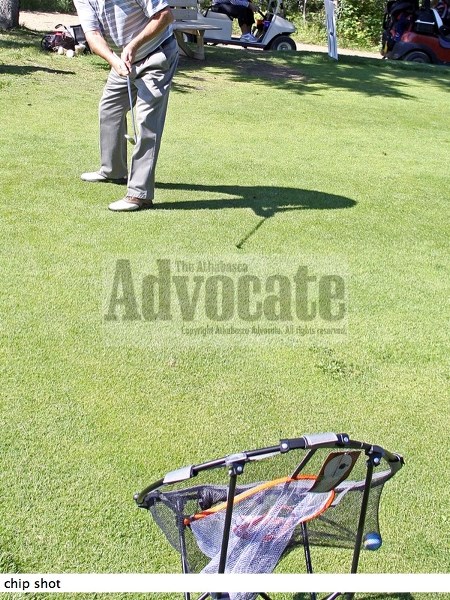 Ole Ellefson makes this chip count in one of the many contests held at various holes around the course.