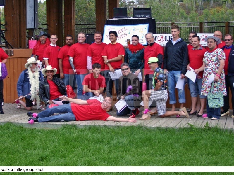The 23 men who participated in the event pose for a group photo.